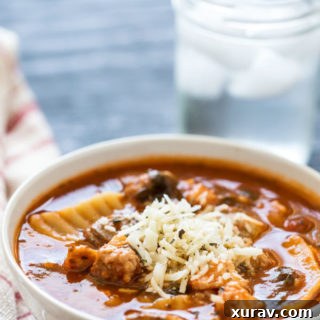 A small circular image of Chicken & Sausage Lasagna Soup, garnished with fresh herbs.