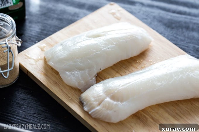 SizzleFish Haddock on a cutting board, ready for preparation.