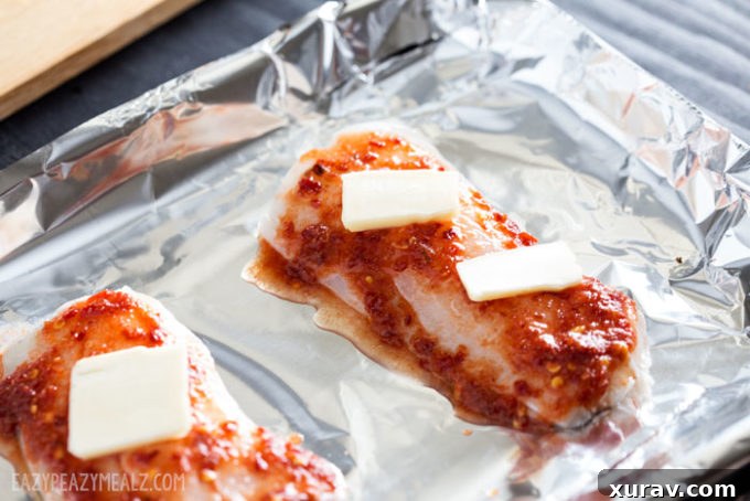 Uncooked haddock fillets, ready for baking.