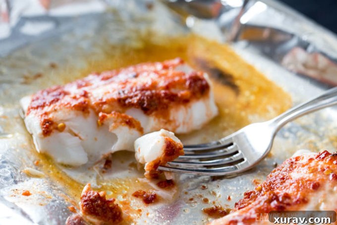 A forkful of flaky harissa baked haddock.