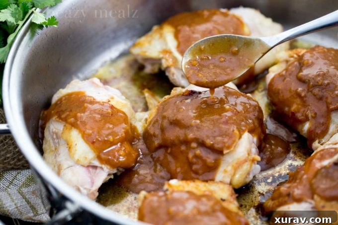 Bowl of creamy peanut butter and a jar of sweet chili sauce, key ingredients for the Thai peanut sauce.