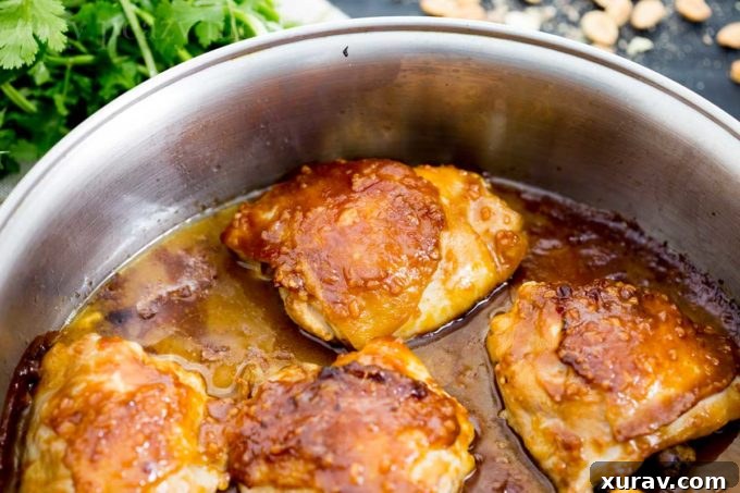 Chicken thighs seared to golden perfection in a hot skillet, ready for sauce and baking.