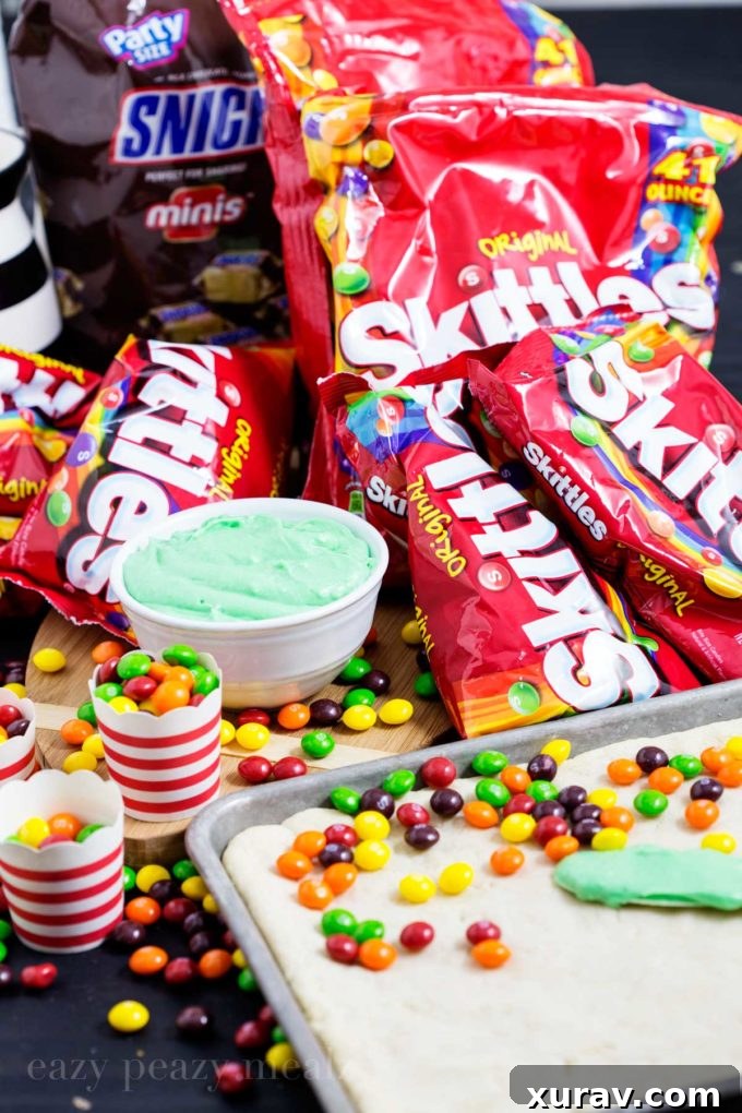 Assorted Skittles and Snickers candies, ideal for game day treats.
