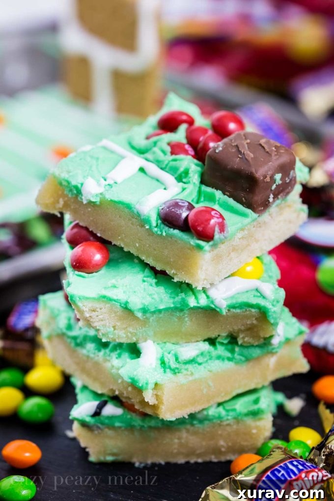 Close-up of football sugar cookie bars decorated with Skittles and frosting details.