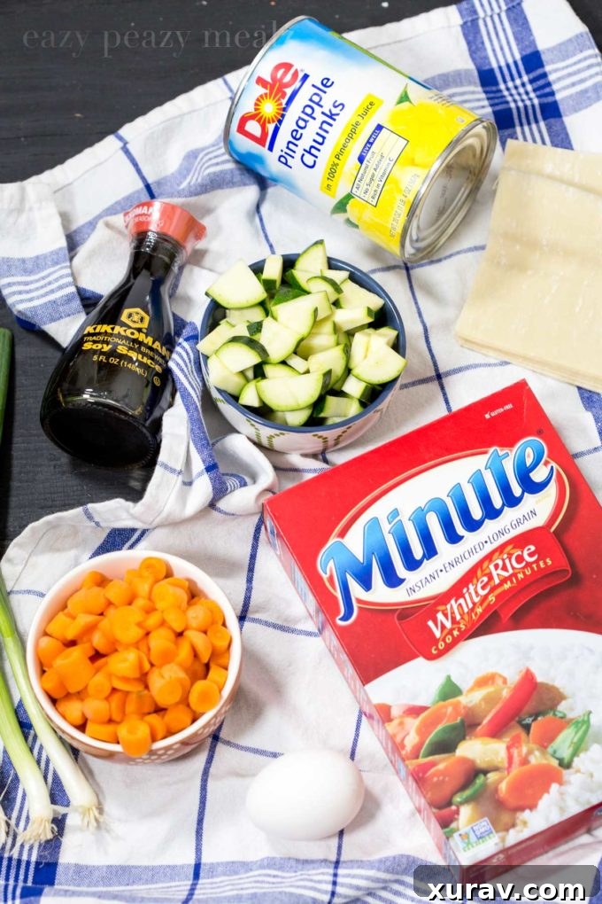 Ingredients for pineapple fried rice egg rolls laid out on a table