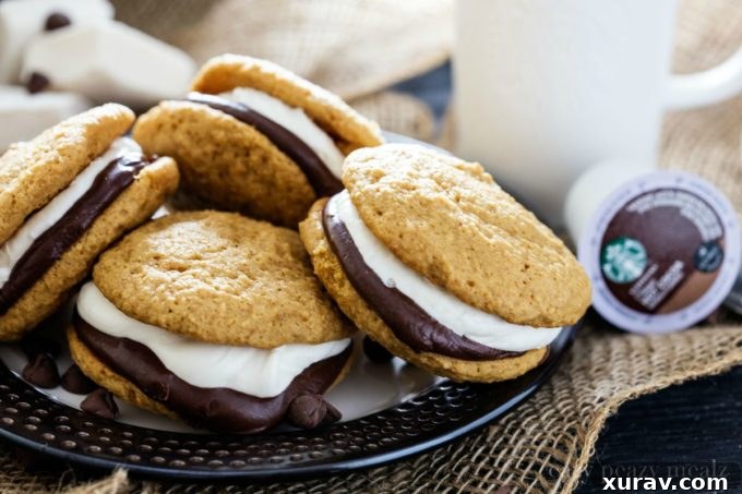 S'mores Whoopie Pie by the plateful! Enjoy these graham cracker cake cookies with chocolate ganache and marshmallow buttercream.