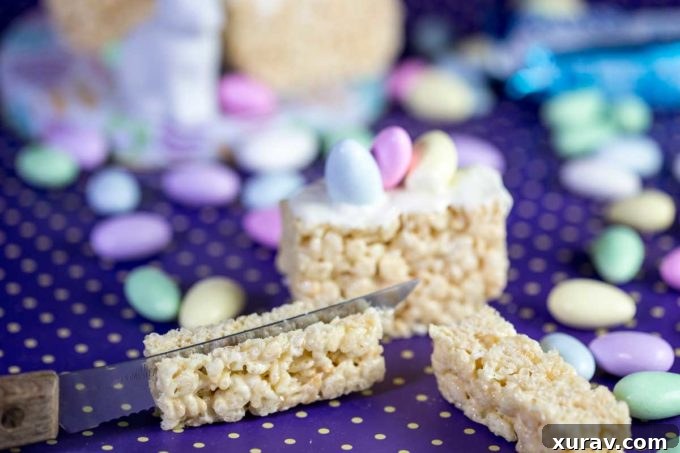 Step 4: Pressing the sugared almonds firmly into the chocolate on the Rice Krispies Treat, ensuring they stand upright.
