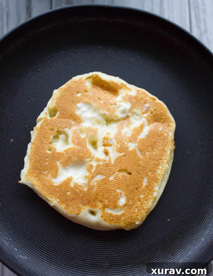 Gallery image of Raspberry Cheesecake Pancakes cooking on a griddle
