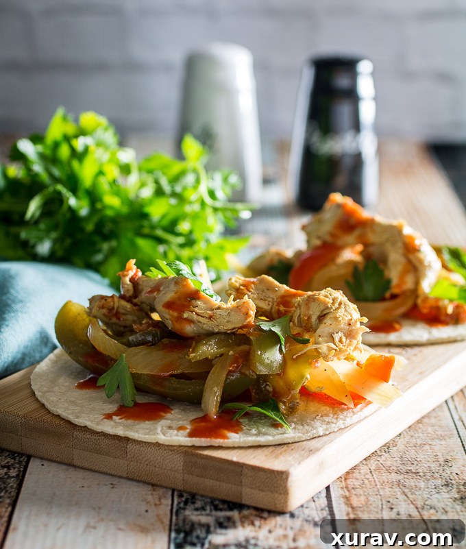 Delicious Slow Cooker Chicken Fajitas served in warm tortillas with fresh toppings