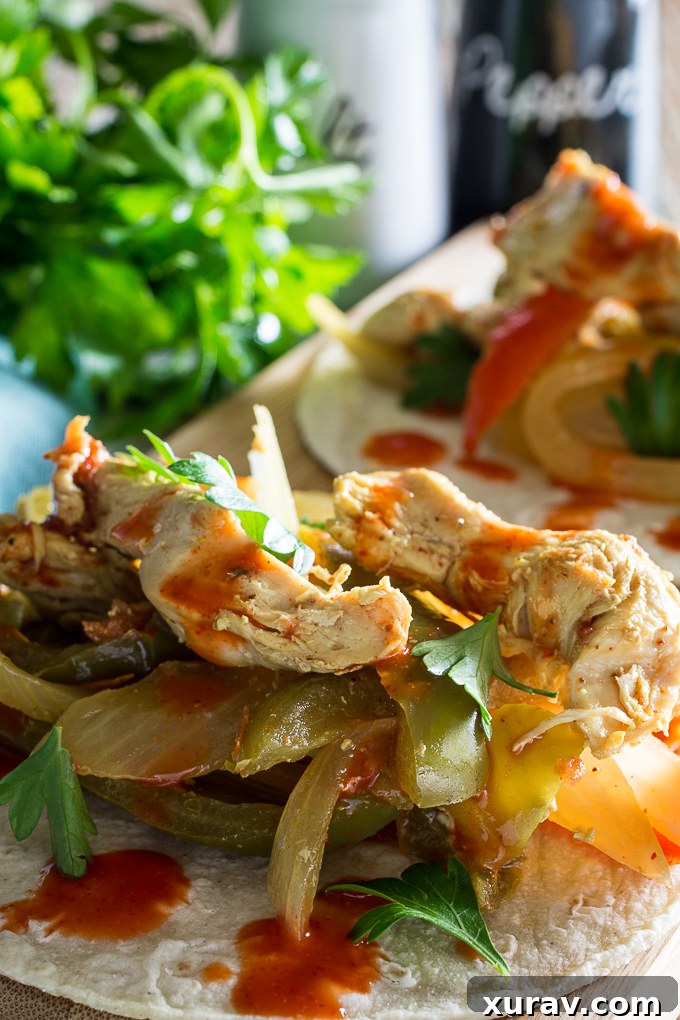 Close-up of slow cooker chicken fajitas, showcasing tender chicken strips and colorful bell peppers