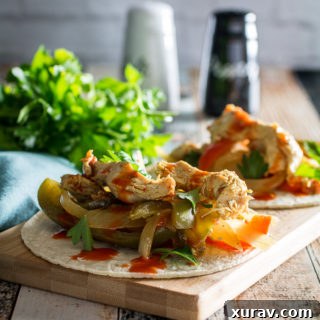 Slow Cooker Chicken Fajitas in a rustic bowl, garnished, ready to serve