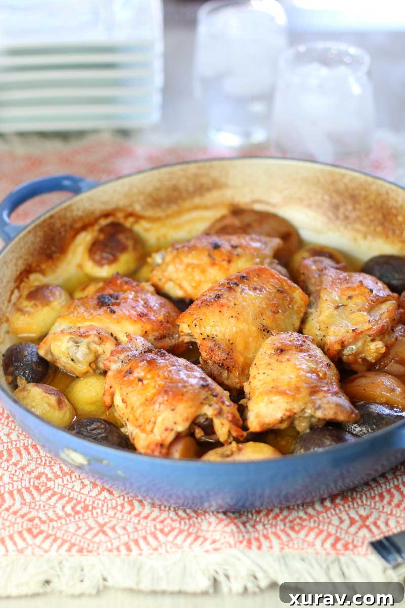 Juicy baked chicken thighs and golden potatoes bathed in a rich lemon garlic sauce, ready to serve.