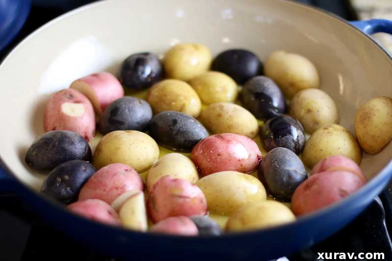 Close-up of small, colorful potatoes sliced and ready to be layered in a baking dish for the chicken recipe.