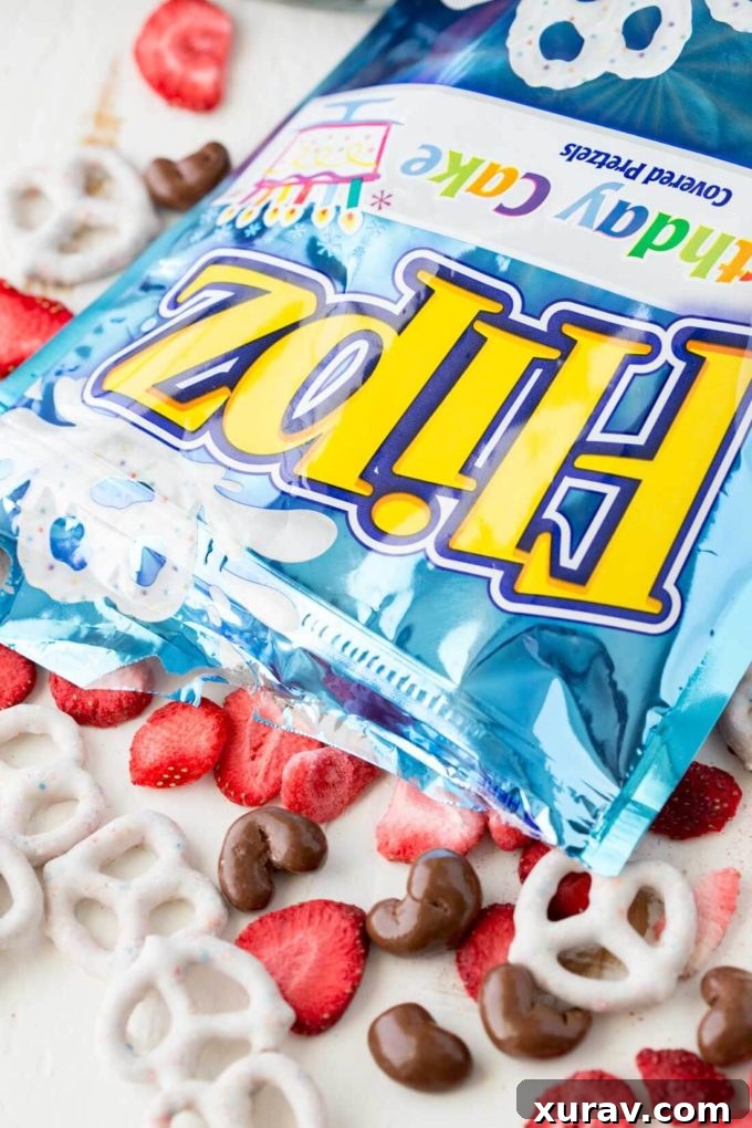 Ingredients for Neapolitan Snack Mix: freeze-dried strawberries, chocolate-covered nuts, and FLIPZ Birthday Cake covered pretzels.