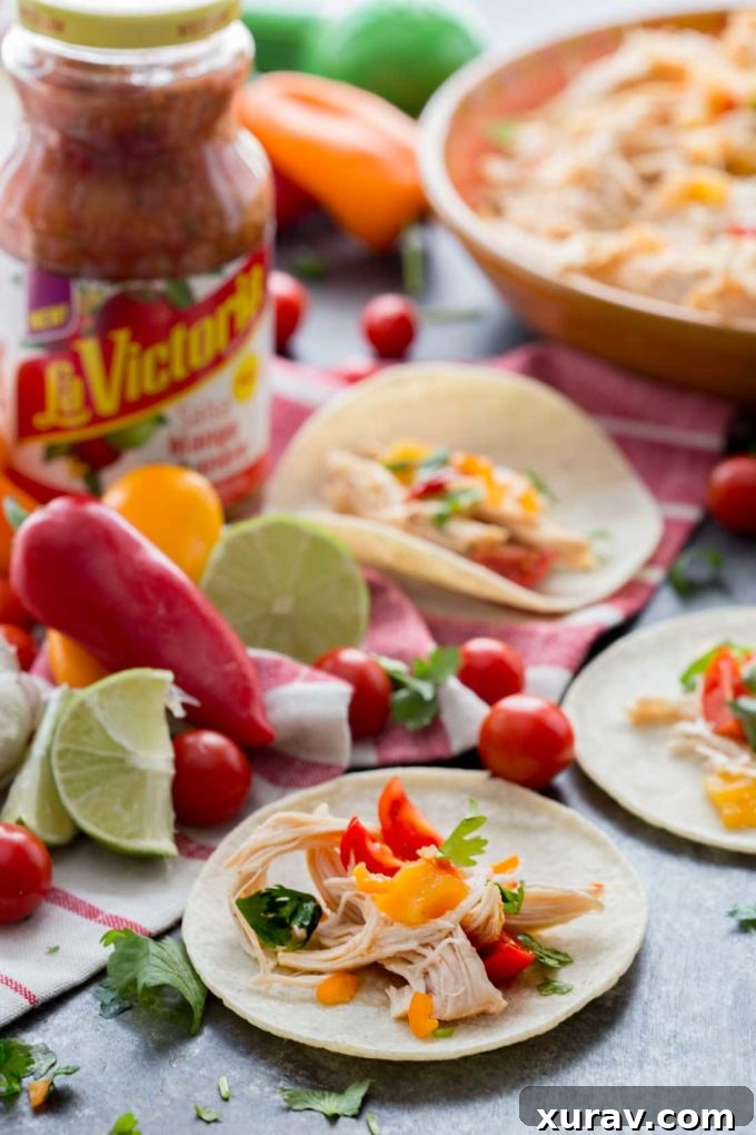 Juicy Slow Cooker Mango Habanero Chicken Tacos, beautifully plated and ready to eat. A perfect blend of sweet and spicy flavors for an easy weeknight meal.
