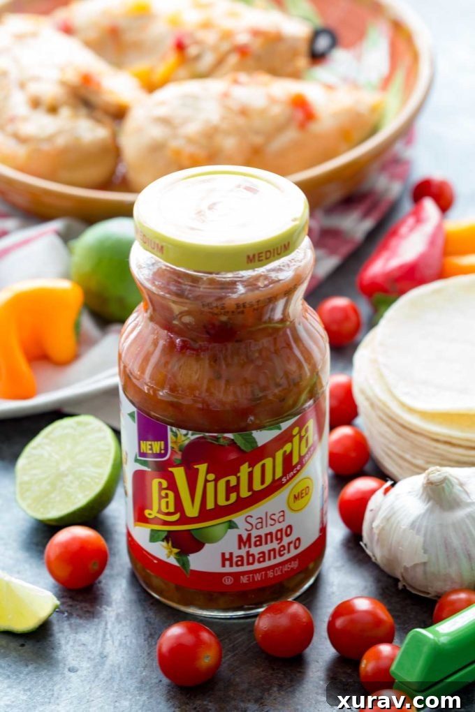 La Victoria Mango Habanero Salsa jar, prominently displayed as the key ingredient for making sweet and spicy chicken tacos effortlessly.
