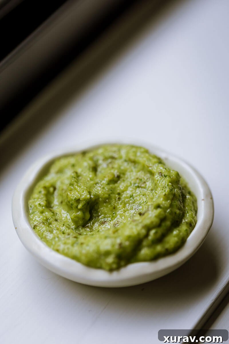 Homemade Basil Pesto - Freshly made pesto in a jar, ready to be enjoyed.