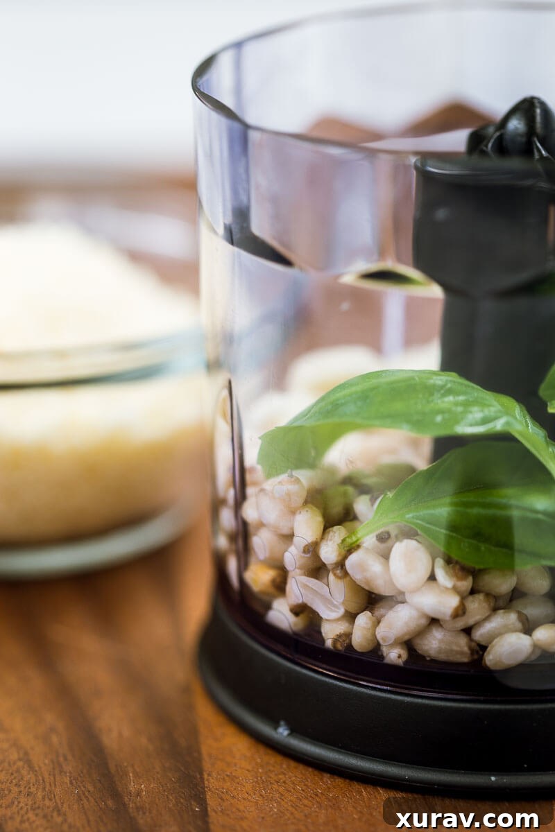 Homemade Basil Pesto - Fresh pesto being mixed in a food processor, showing its smooth texture.
