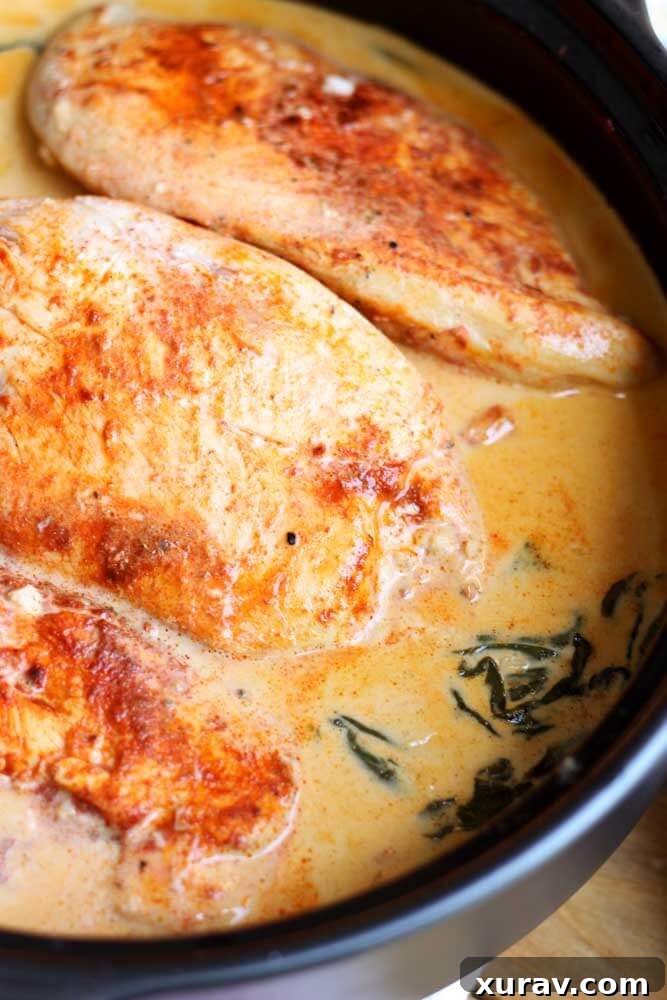 Close up of Lemon Butter Chicken, uncooked in a skillet, showcasing golden-brown chicken and rich sauce