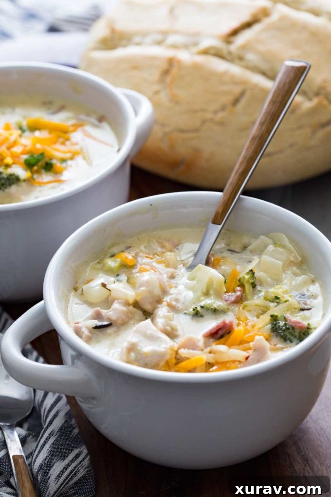 Creamy Chicken, Bacon, Broccoli, and Cheddar Wild Rice Soup simmering in a slow cooker, garnished with fresh parsley.