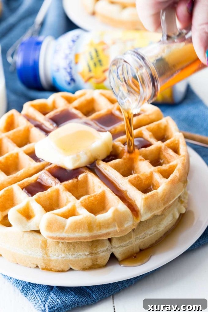A plate of golden, fluffy classic waffles, perfectly cooked and ready to be served, with a hint of a secret ingredient for picky eaters
