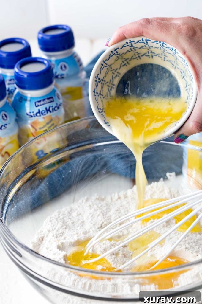 A freshly cooked classic waffle being removed from the waffle iron, showcasing its perfect golden-brown texture, ready for a kid-friendly twist
