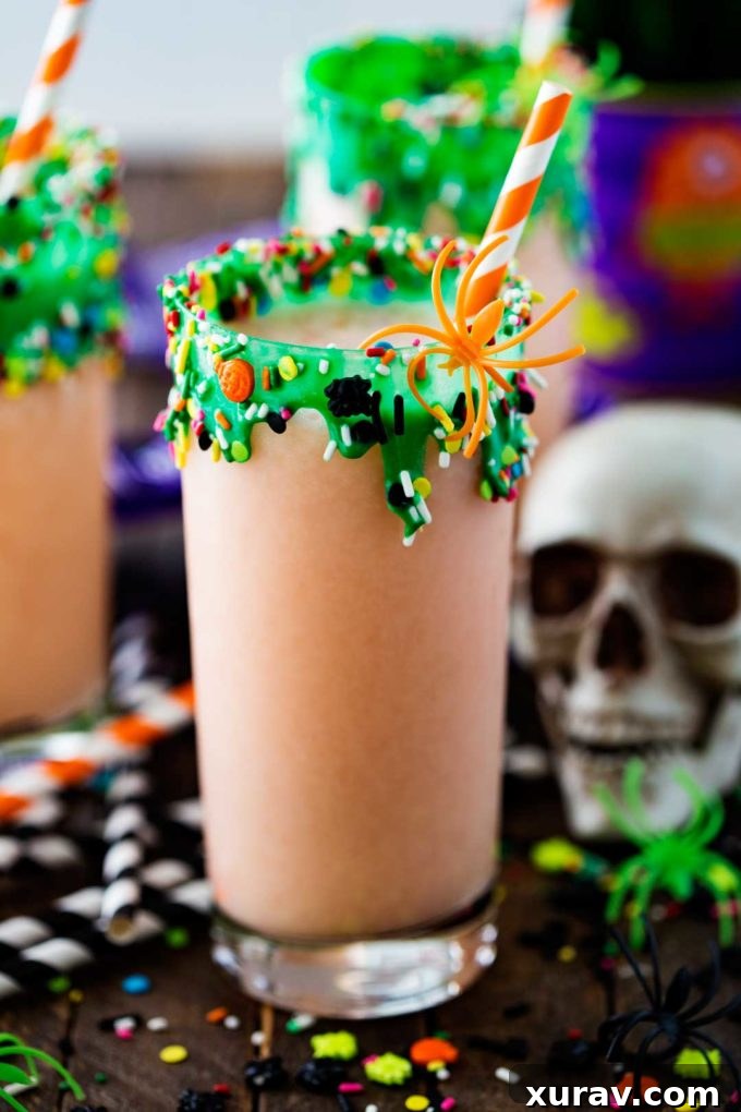 Vibrant green Swamp Potion Halloween punch in a decorated glass, perfect for a spooky party