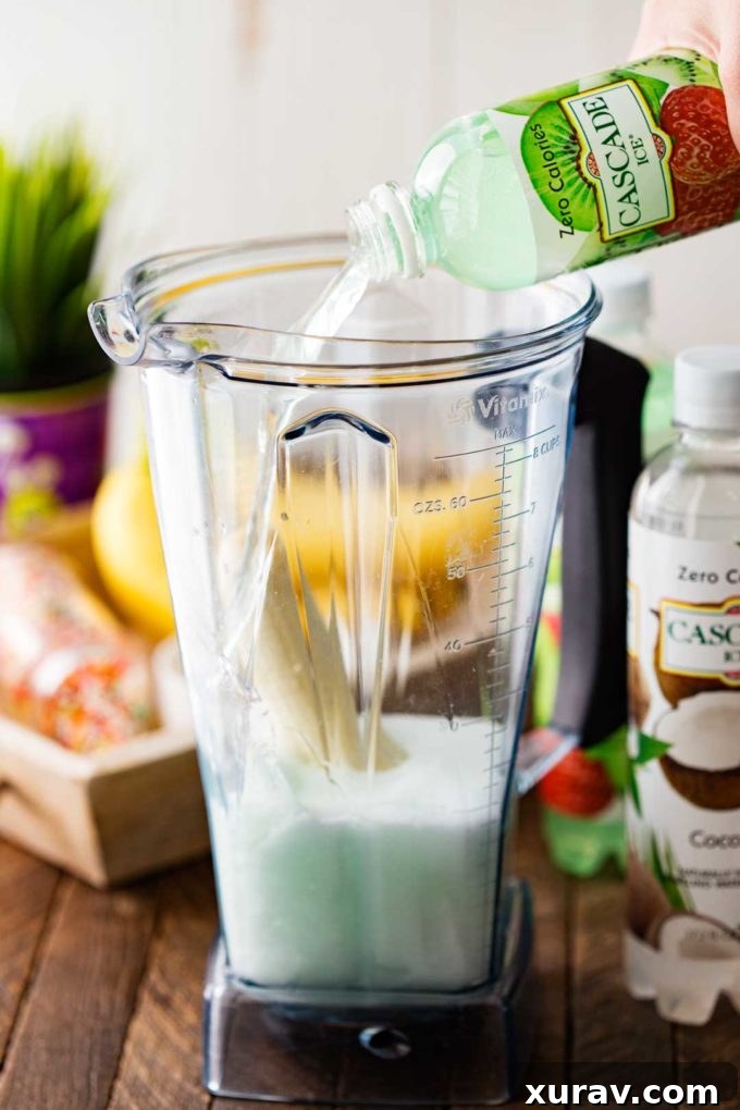 Ingredients for Swamp Potion Punch being blended in a high-powered blender for a smooth, creamy texture