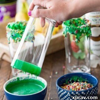 A beautifully decorated glass of Swamp Potion Punch, highlighting the festive Halloween theme