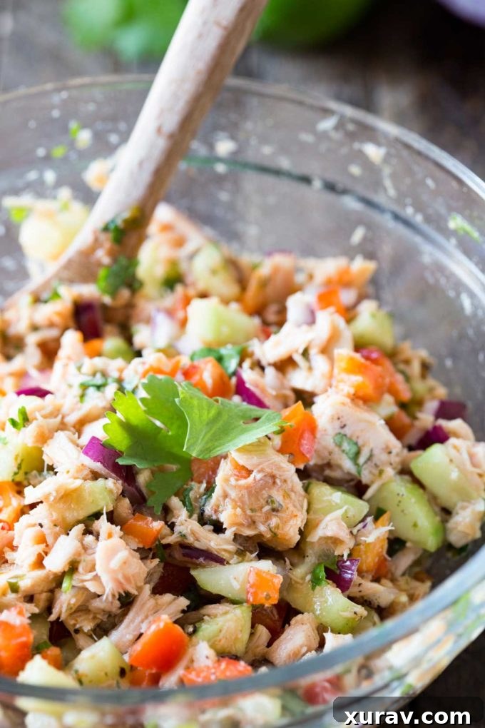 A beautifully mixed Thai tuna salad, featuring fresh, finely chopped vegetables and aromatic Thai-inspired spices, ready for serving.