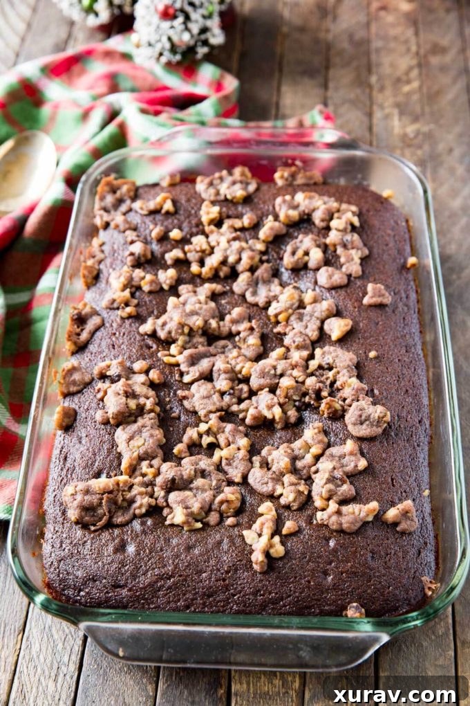 A beautifully baked gingerbread cake, rich in color and texture, presented whole before slicing.
