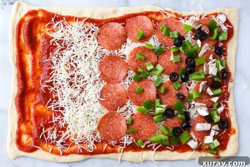 Close-up of freshly baked Supreme Pizza Pinwheels, showing the golden crust and vibrant fillings.
