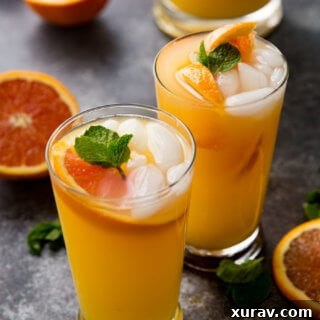 A small, stylized image of a glass of Mango Orange Mojito, emphasizing its appeal for a recipe card.