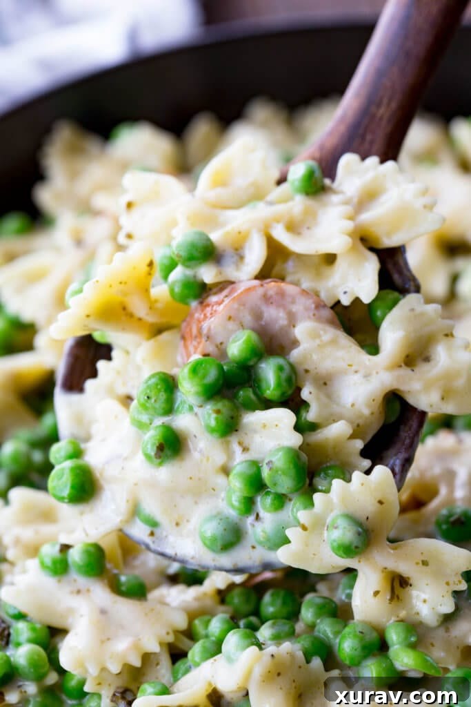 Quick, easy, and oh so delicious, this skillet pasta is a real winner with chicken sausage, peas, alfredo, and pesto