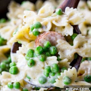 Quick, easy, and oh so delicious, this skillet pasta is a real winner with chicken sausage, peas, alfredo, and pesto