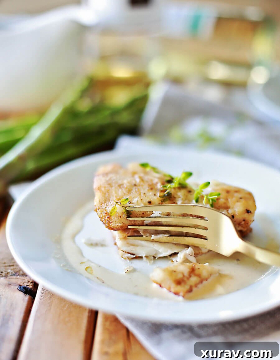 Gourmet haddock dish with white wine sauce and fresh herbs, perfect for an elegant dinner.