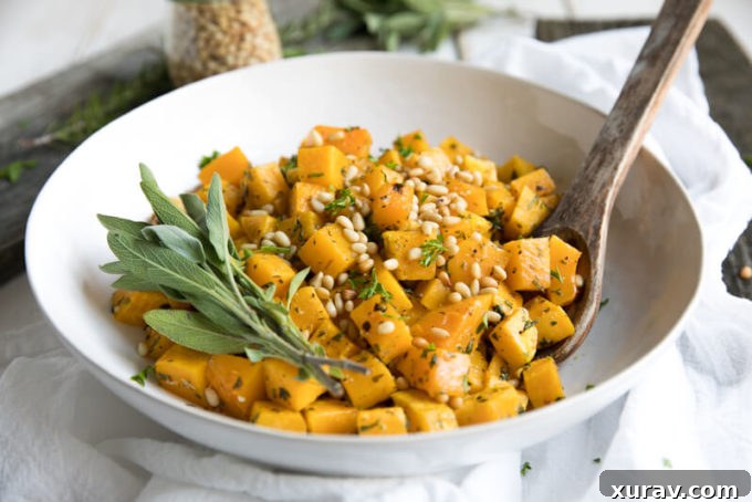 Three serving bowls of oven roasted garlic and herb butternut squash, ready to eat