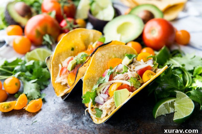 Slow Cooker Honey Lime Chicken Tacos with all the toppings, perfect for a customizable taco bar.