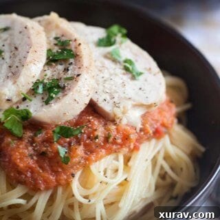 The finished dish: perfectly roasted chicken slices with a rich, vibrant tomato sauce, ready to be served.