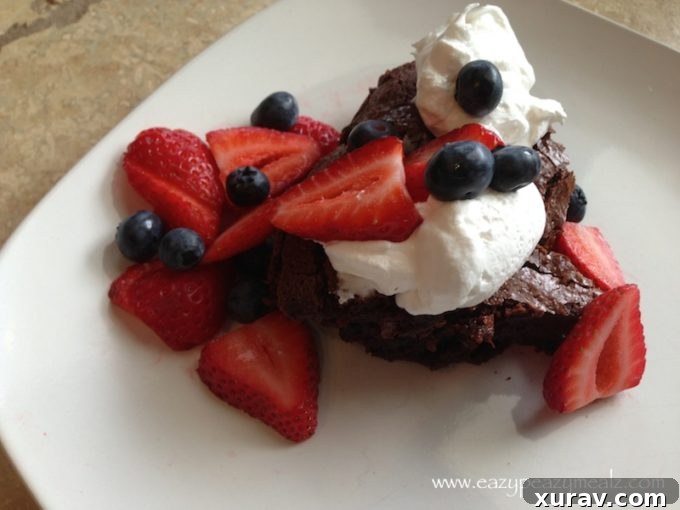 Rich chocolate ganache cake on a serving plate, ready to be enjoyed
