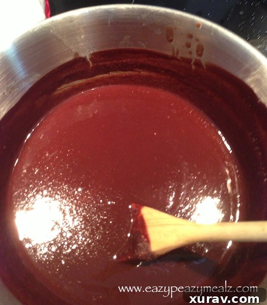 Granulated sugar being stirred into the chocolate-butter mixture