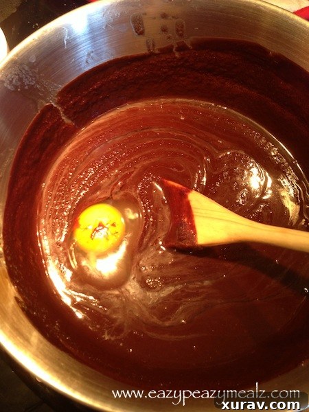 Room temperature eggs being mixed into the chocolate cake batter