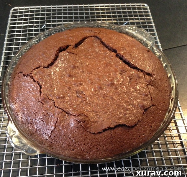 Freshly baked chocolate ganache cake cooling in its pan