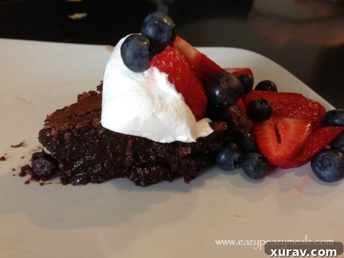 Close-up of a perfectly sliced chocolate cake adorned with fresh berries
