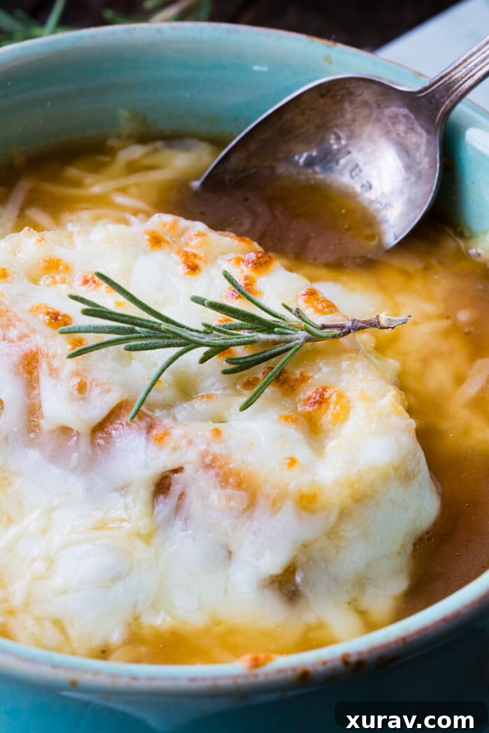 Oven-safe bowls of French Onion Soup topped with cheese and bread, ready to be broiled