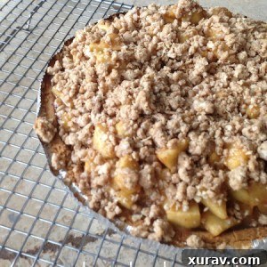 A close-up of a homemade Caramel Apple Cheesecake slice