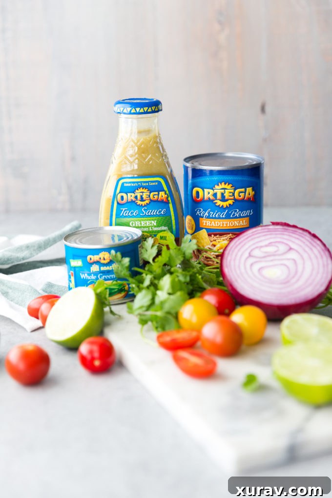 Ingredients laid out for a vibrant Cinco de Mayo taco bar with Slow Cooker Pork Carnitas