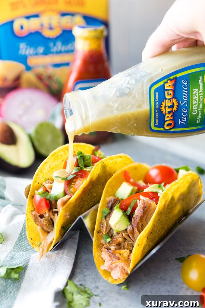 A finished Slow Cooker Pork Carnitas Taco ready to be enjoyed, showcasing crispy pork and fresh toppings