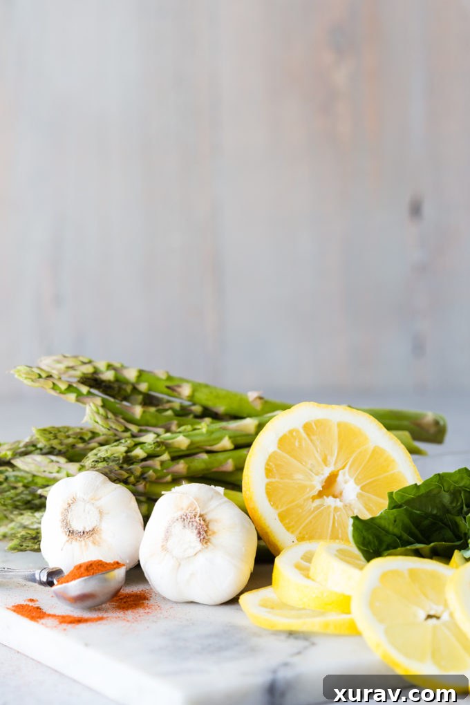 Everything you need to make delicious lemon butter salmon foil packets, baked with asparagus, ingredients laid out