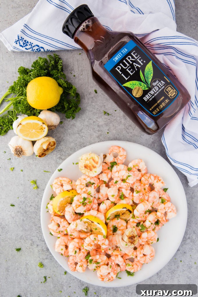 A large platter of golden-brown garlic butter shrimp, ready to be served at a gathering.
